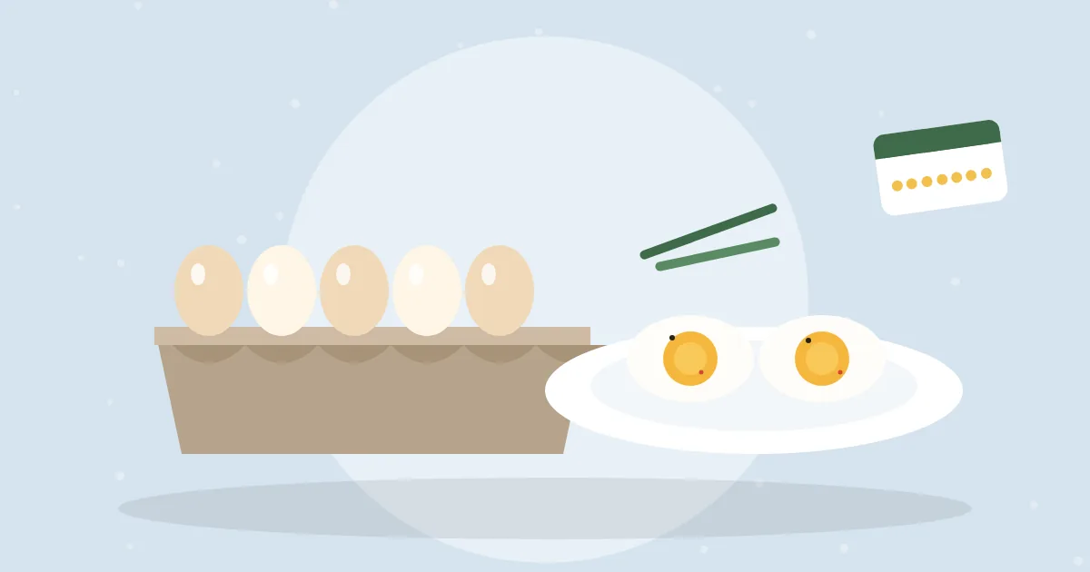 Carton of hard-boiled eggs next to a plate with two halved eggs and chives